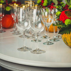 wine glasses on the table for drinks (close-up partial view). Festive crystal