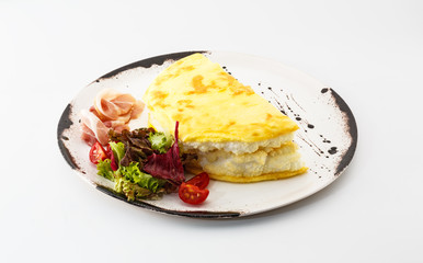 breakfast with scrambled eggs, salad and meat on a white plate isolated on white background