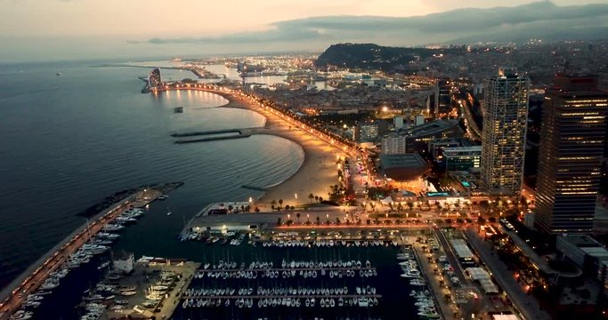 Barcelona seashore on Mediterranean in night lights, aerial view