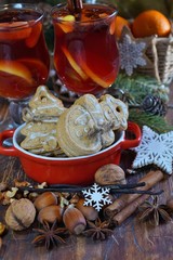 Decorative cookies in the shape of a Christmas tree and snowman and mulled wine with spices. 
