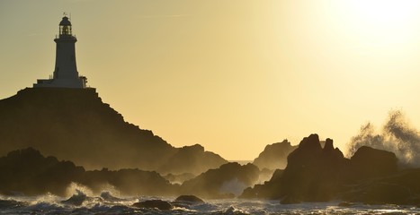La Corbiere lighthouse, Jersey, U.K.  Autumn high tide at sunset. © alagz