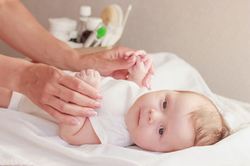 Baby and hands of mother, soft focus background