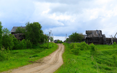 The dirt road in an abandoned village in the Kostroma region in summer, Russia