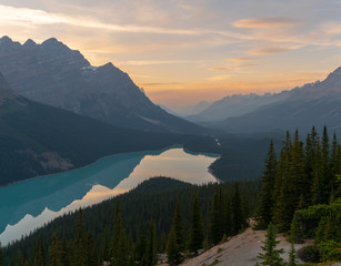 The orange glow of sunset over Peyto Lake in Banff National Park with some late alpen glow