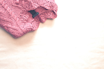 Pink sweater on the craft background.