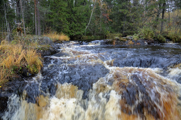 Scenic Karelian waterfall Ahvenkoski in autumn. Russia
