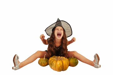 little girl with long hair in witch outfit on Halloween with pumpkins, emotionally expressions of...
