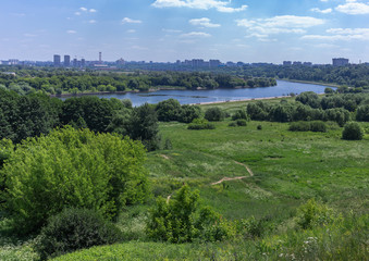 Summertime landscape panorama -river valley with hills
