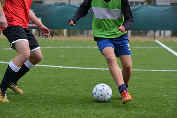 young soccer players are fighting for the ball