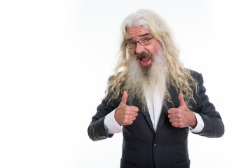 Studio shot of happy senior bearded businessman smiling while gi