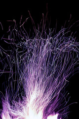 Sparks and flame of fire inferno, background or texture. Design element, isolated on black. Long exposure
