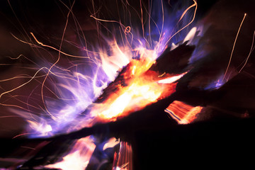 Bright sparks with blue flame. Abstract fire on a black background