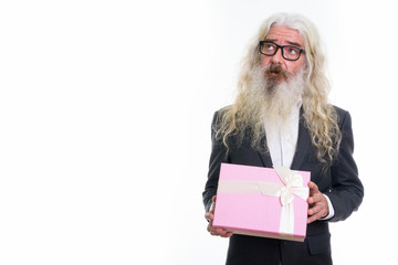 Studio shot of senior bearded businessman thinking while holding