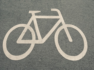 White Bicycle Sign On Asphalt Road In Berlin, Germany