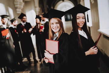 Diploma. Standing. Corridor. Girls. Happiness.