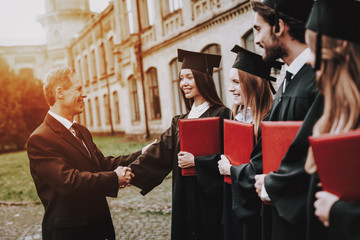 Teacher. Students Diplomas. Courtyard. University.