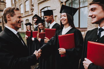 Cheerful. Teacher. Handshake. Students Diplomas.