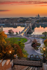 Budapest, Hungary - The famous Szechenyi Chain Bridge (Lanchid) and Clark Adam Square roundabout at sunrise with nice autumn foliage