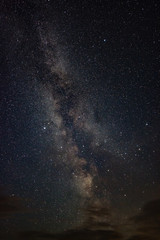 Bright milky way on a summer night through the clouds