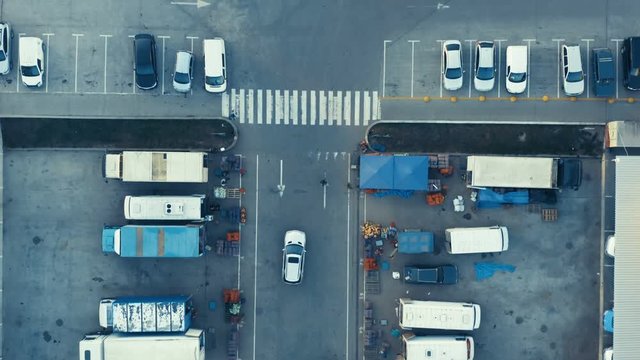 Aerial top view of the wholesale and retail market with lots of trucks and cars