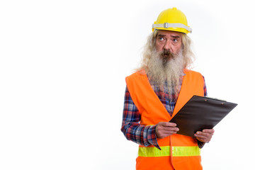 Studio shot of senior bearded man construction worker holding cl