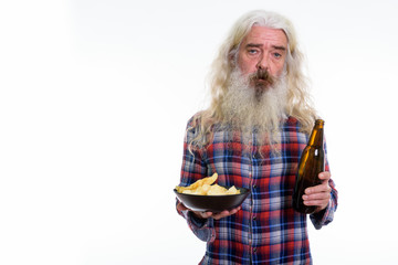 Studio shot of senior bearded man holding bottle of beer and bow