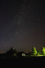 House in Russian village on a starry summer night