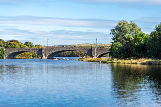 A couple of  kayaks passing under a bridge while practising rowing in river Dee, Aberdeen, Scotland