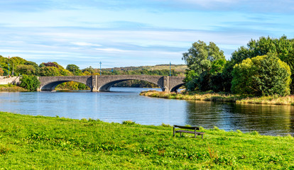 Fototapeta na wymiar A scenic view of am ached bridge and river Dee in a beautiful sunny day, Aberdeen, Scotland