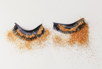 Black false eyelashes with gold glitter