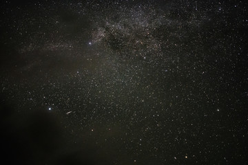 Bright milky way on a summer night through the clouds
