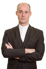Close up of bald Caucasian businessman with arms crossed