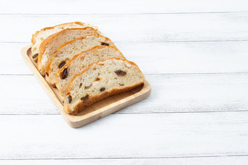 slices raisin bread on wooden board