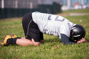 american football player resting after hard training