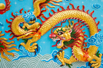 Fototapeta premium Beautiful colorful painting low relief dragon sculpture in Chinese temple wall, Kanchanaburi Thailand