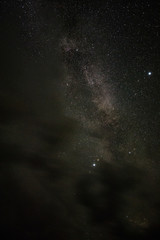 Bright milky way on a summer night through the clouds