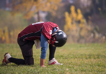 american football player resting after hard training