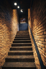 Staircase in old cellar with brick walls. Loft staircase with brick walls