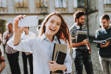 Selfie. Phone. Girl. Happy. Students. Courtyard.