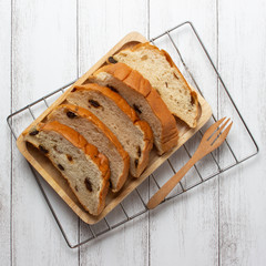 slices raisin bread on wooden board