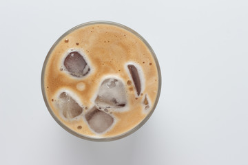 Glass of ice coffee isolated on white background from top view