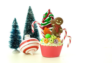 Fototapeta na wymiar On-trend candyland festive Christmas cupcakes on white background.