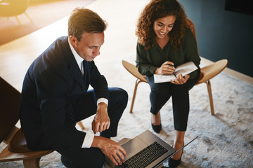 Diverse work colleagues discussing business together in an offic