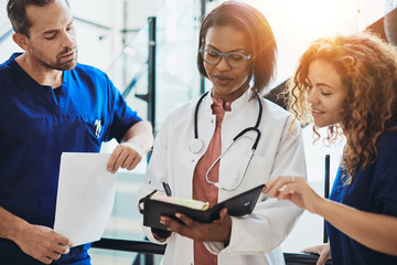 Diverse group of doctors talking together in a hospital corridor