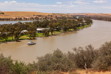 Landscape view of houseboat cruising upstream on the Murray River near Young Husband in South...