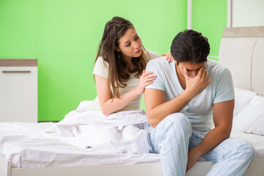Young woman consoling disappointed impotent husband 