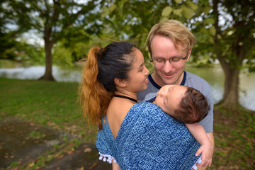 Fototapeta premium Multi-ethnic young family bonding together at the park