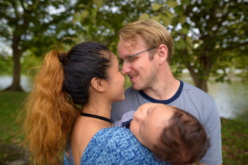 Fototapeta premium Multi-ethnic young family bonding together at the park