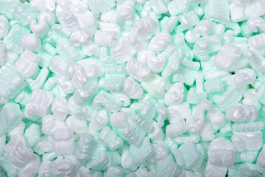 Flat lay of of foam packing peanuts. Foam peanuts, or foam popcorn, packing peanuts or packing noodles, are a common loose-fill packaging and cushioning material used to prevent damage during shipping