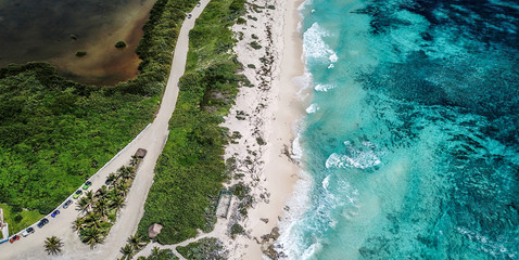 Drone shoot of tropical beach line with waves cursing on the cost line 